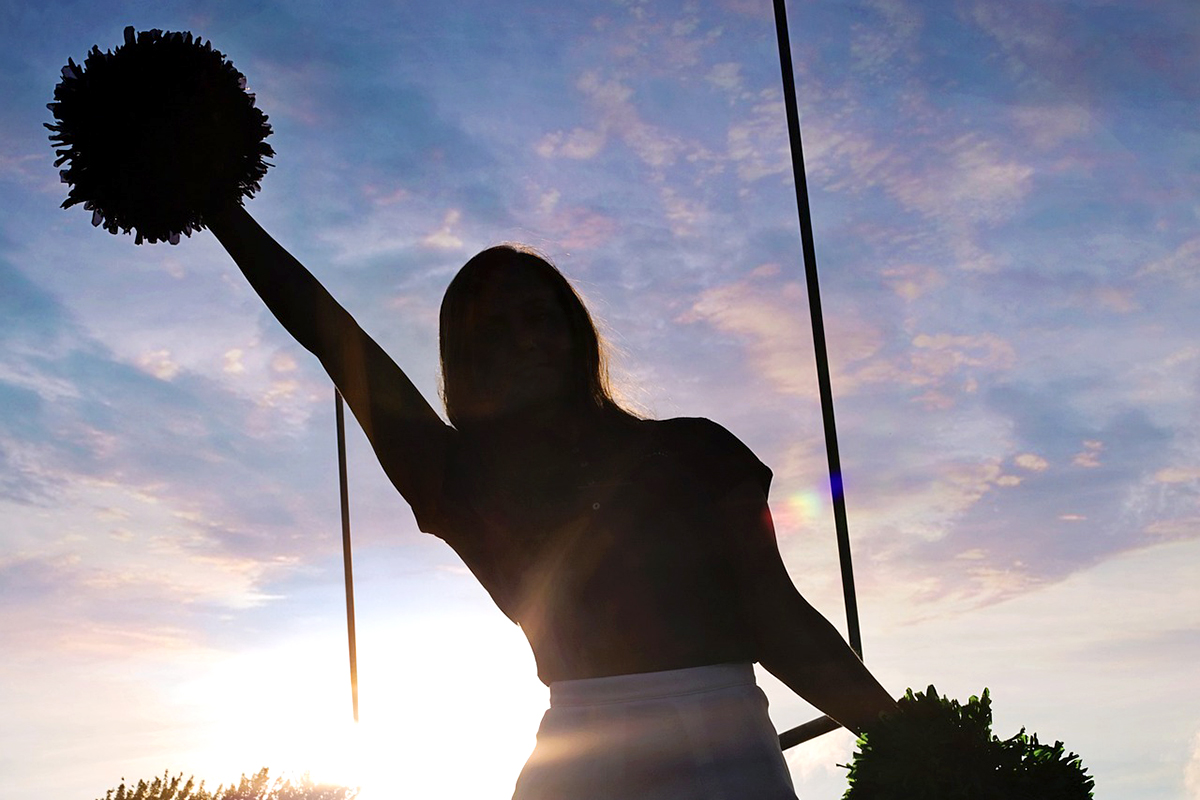 A cheerleader in the sunset