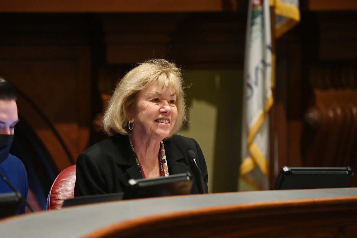 Senator Morrison seated in front of a computer during a committee hearing.